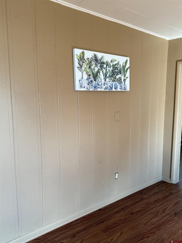 interior space featuring dark wood-type flooring and crown molding