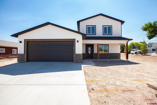 670 Nuvue St Cyprus Floorplan, Cyprus Floorplan, Delta, CO 81416 - view of front of property featuring stucco siding, a garage, stone siding, driveway, and covered porch