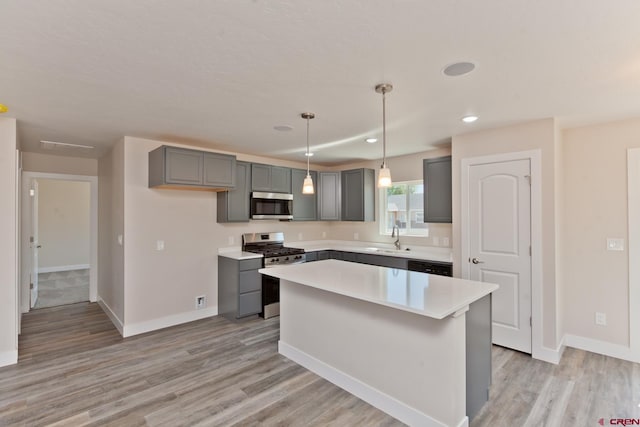 670 Nuvue St Cyprus Floorplan, Cyprus Floorplan, Delta, CO 81416 - kitchen with stainless steel appliances, gray cabinetry, light countertops, light wood-style floors, and a center island