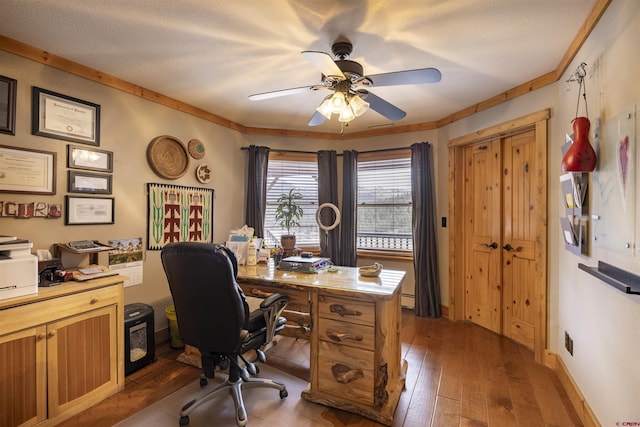 office featuring dark wood-style flooring, baseboard heating, ornamental molding, ceiling fan, and a textured ceiling