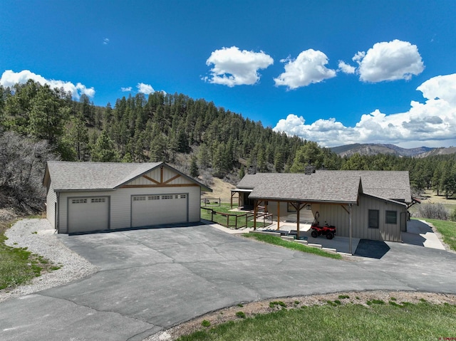 250 Sunset Ln, Durango, CO 81301 - ranch-style home featuring board and batten siding, an outdoor structure, roof with shingles, and a detached garage