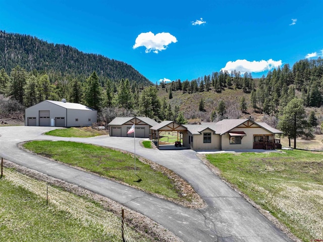 250 Sunset Ln, Durango, CO 81301 - exterior space featuring a garage, a forest view, and a front yard