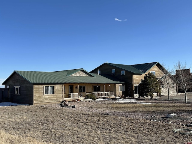 view of front of home with metal roof and a porch