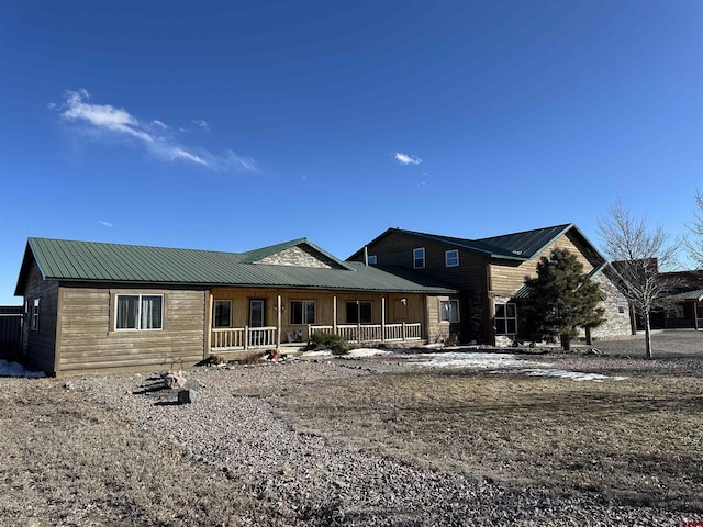 view of front of home featuring covered porch and metal roof