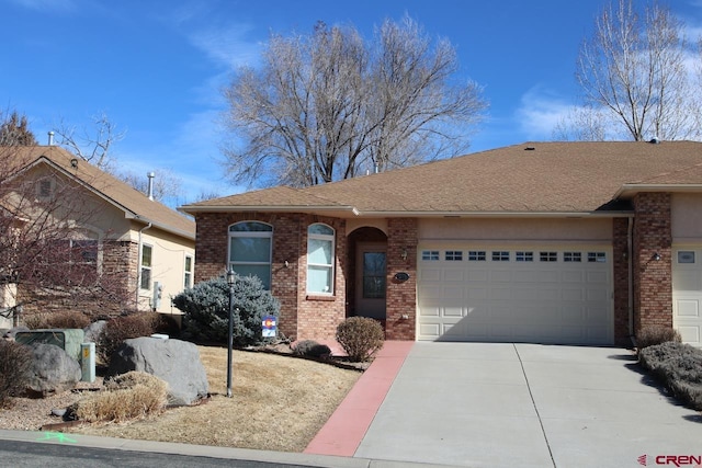 ranch-style home featuring driveway, a shingled roof, a garage, and brick siding