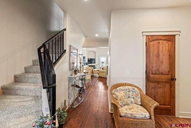 interior space featuring recessed lighting, arched walkways, and wood finished floors