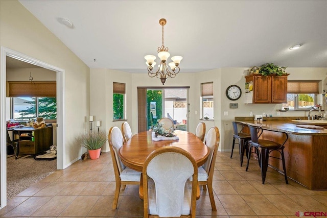 dining space featuring a healthy amount of sunlight, light tile patterned floors, baseboards, and a chandelier