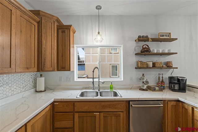 kitchen with pendant lighting, open shelves, stainless steel dishwasher, brown cabinetry, and a sink