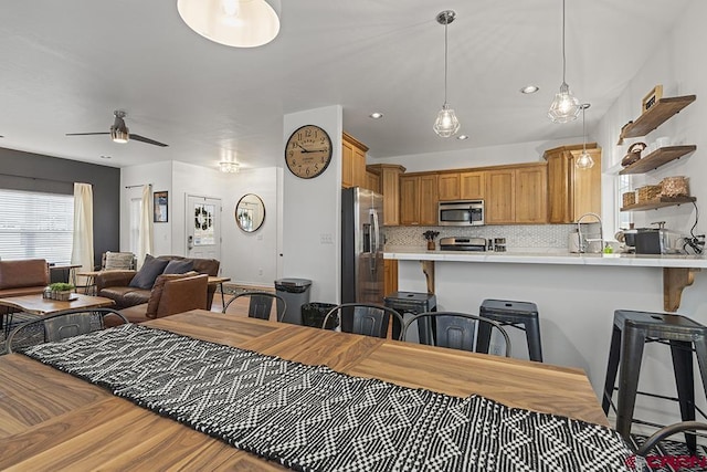 dining room featuring light wood-style floors, ceiling fan, and recessed lighting