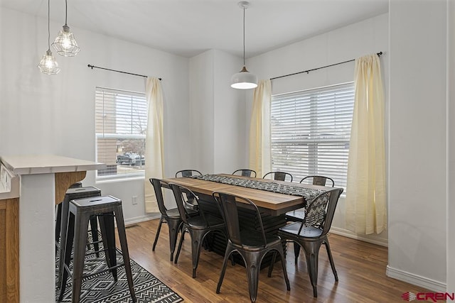 dining area with wood finished floors and baseboards