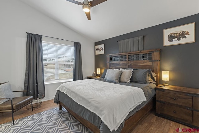 bedroom featuring baseboards, a ceiling fan, vaulted ceiling, and wood finished floors