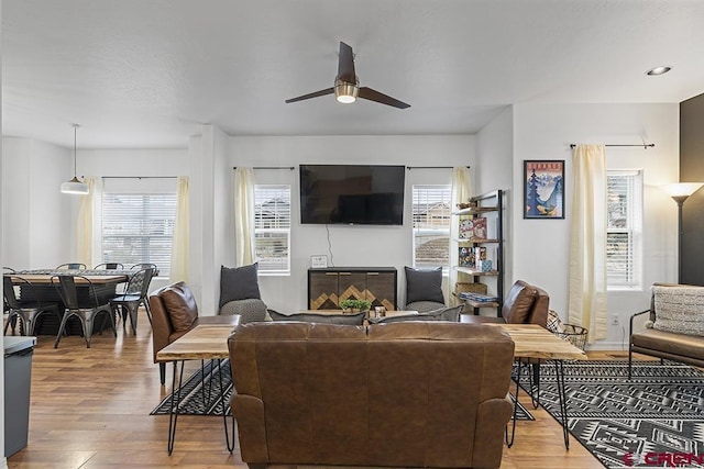 living room featuring a ceiling fan, recessed lighting, and wood finished floors