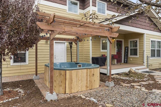 view of patio featuring a pergola, a wooden deck, and a hot tub