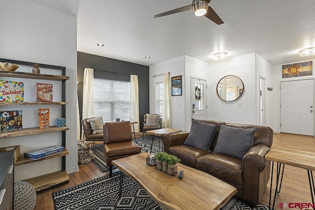 living area featuring ceiling fan and wood finished floors