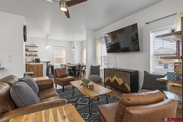 living area with ceiling fan and wood finished floors