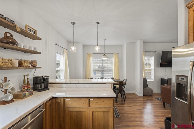 kitchen with stainless steel appliances, a peninsula, open shelves, and brown cabinets