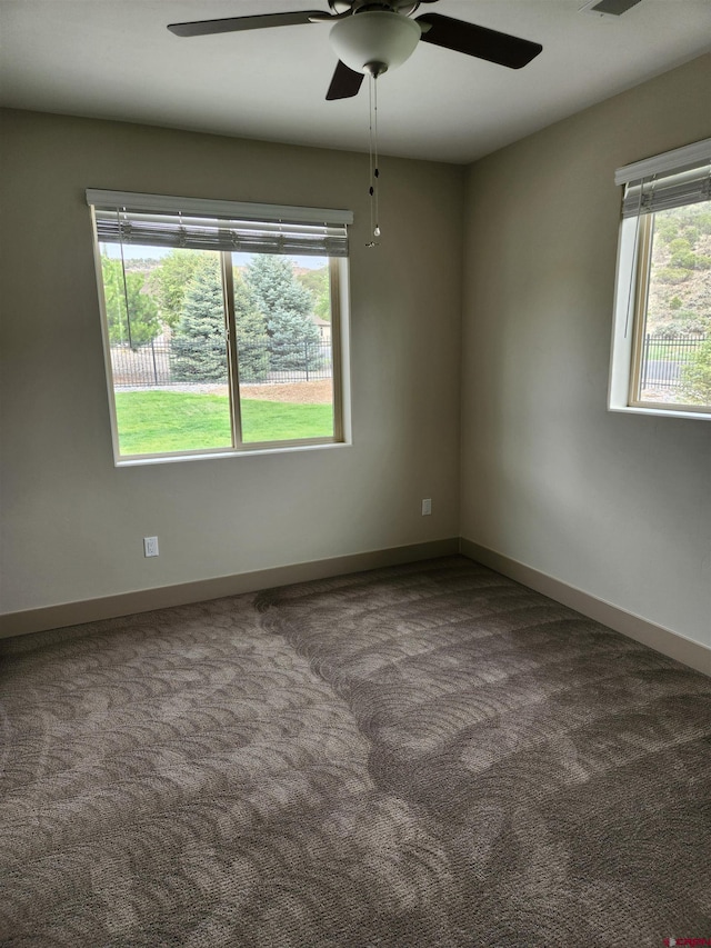 carpeted empty room with baseboards