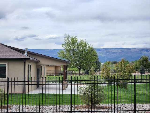 exterior space with fence private yard and a mountain view