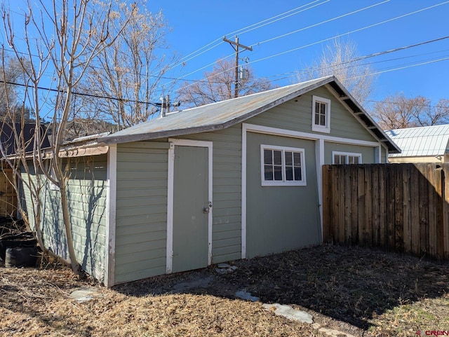 view of outdoor structure with an outbuilding and fence