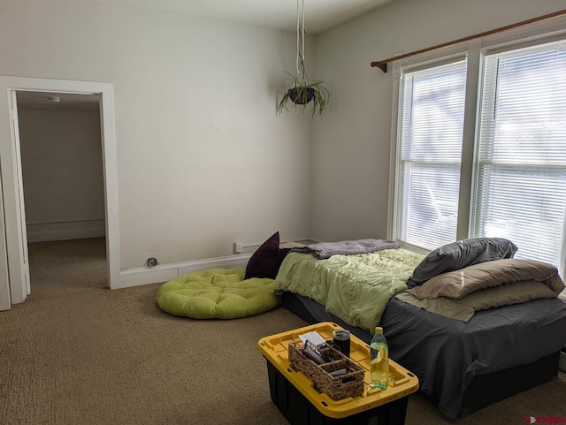 carpeted bedroom featuring baseboards