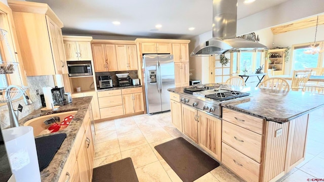 kitchen with a kitchen island, appliances with stainless steel finishes, light brown cabinetry, tasteful backsplash, and island exhaust hood