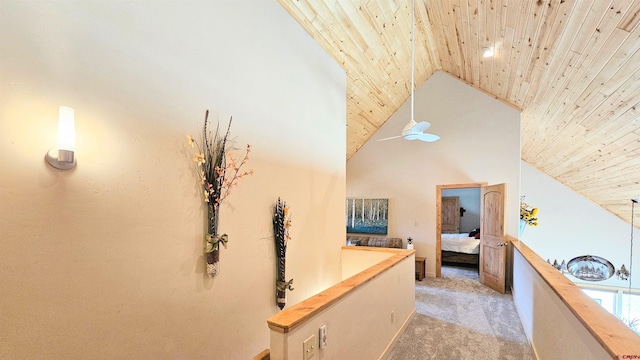 hallway featuring light carpet, high vaulted ceiling, and wood ceiling