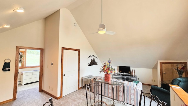 office space featuring high vaulted ceiling, ceiling fan, baseboards, and light colored carpet