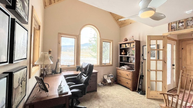 home office featuring ceiling fan, high vaulted ceiling, and light carpet