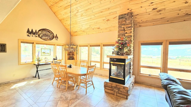 dining room with light tile patterned floors, high vaulted ceiling, wooden ceiling, and a fireplace