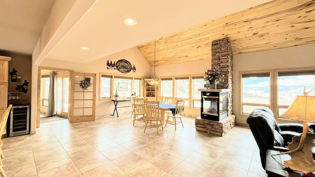 dining space with wine cooler, light tile patterned floors, recessed lighting, wood ceiling, and vaulted ceiling