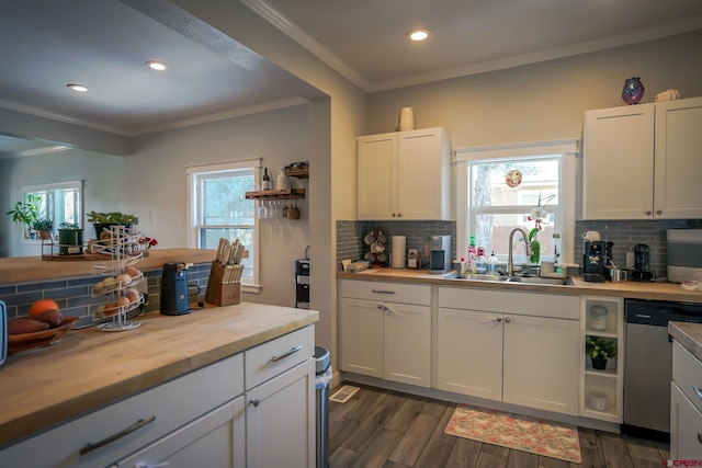 kitchen featuring white cabinetry, dishwasher, and a sink