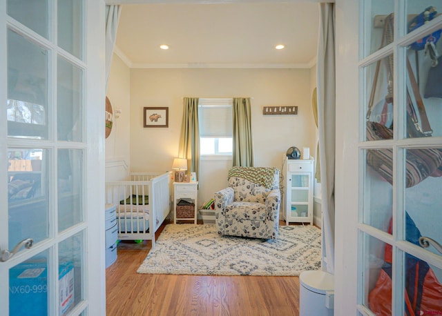 bedroom featuring recessed lighting, french doors, crown molding, and wood finished floors