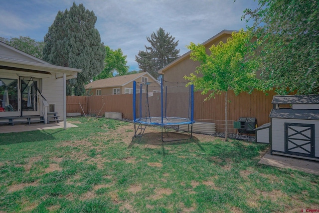 view of yard with a fenced backyard and a trampoline