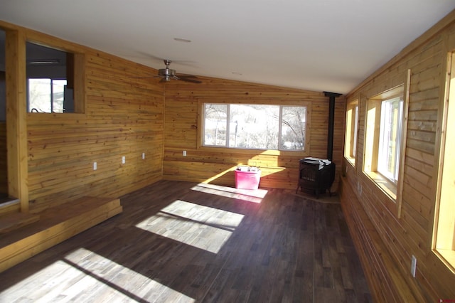 empty room with lofted ceiling, dark wood finished floors, and a wealth of natural light