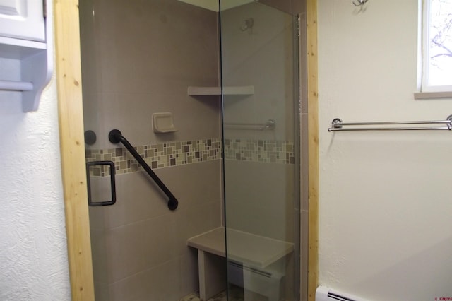 bathroom with a stall shower and a baseboard radiator