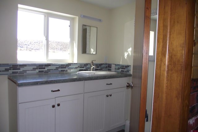 bathroom with backsplash and vanity