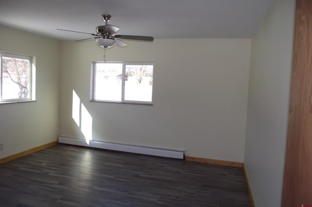 spare room with baseboards, a baseboard heating unit, dark wood finished floors, and a ceiling fan