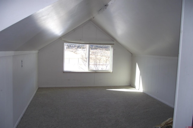 bonus room featuring lofted ceiling and carpet