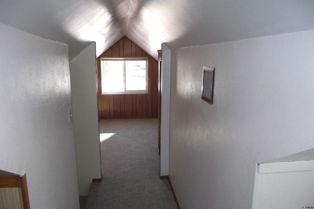 hall with carpet and vaulted ceiling