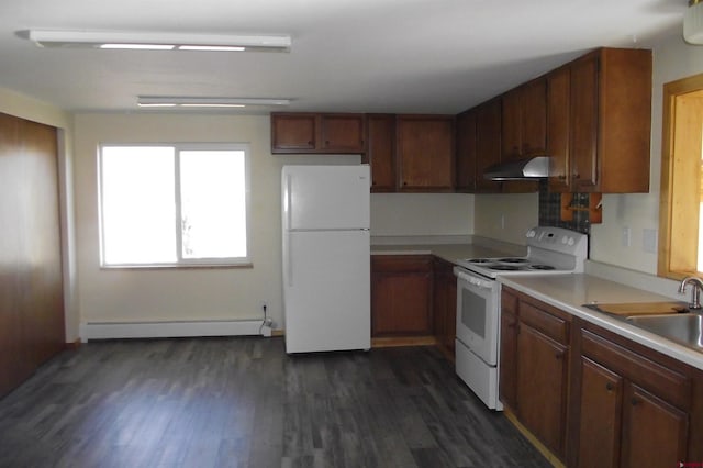 kitchen featuring light countertops, a baseboard heating unit, a sink, white appliances, and under cabinet range hood