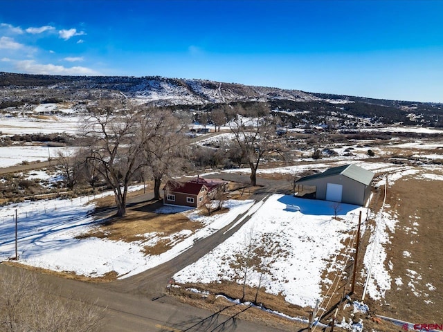 snowy aerial view featuring a mountain view