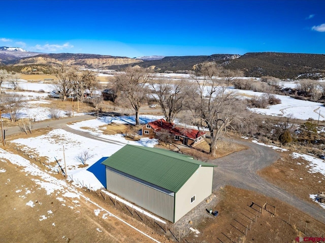 snowy aerial view with a mountain view