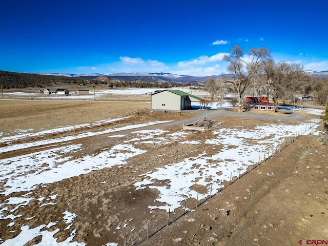 snowy yard featuring a mountain view