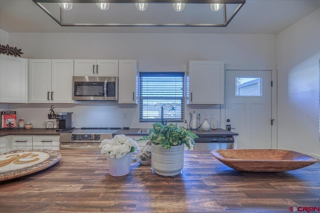 kitchen featuring dark countertops, white cabinetry, and appliances with stainless steel finishes