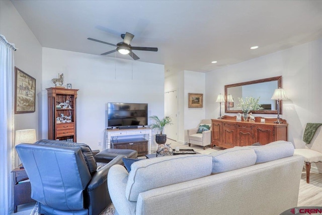 living area with a ceiling fan, recessed lighting, and light wood-style flooring