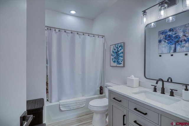 bathroom featuring toilet, shower / tub combo, and vanity