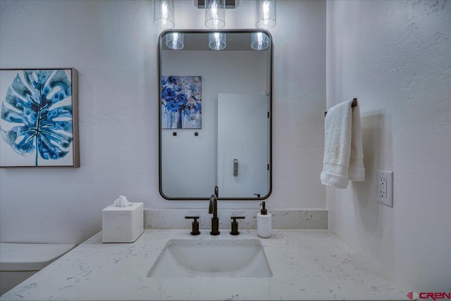 bathroom with toilet and vanity