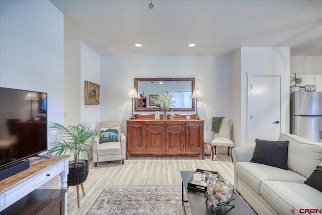 living room featuring light wood-type flooring and recessed lighting