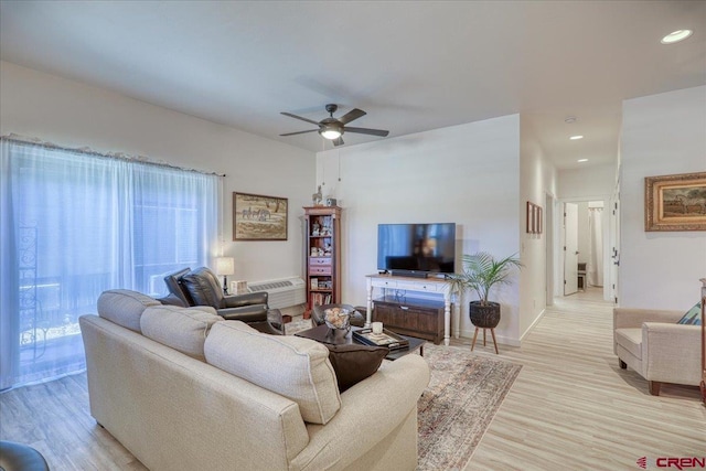 living room featuring recessed lighting, a healthy amount of sunlight, ceiling fan, and light wood finished floors