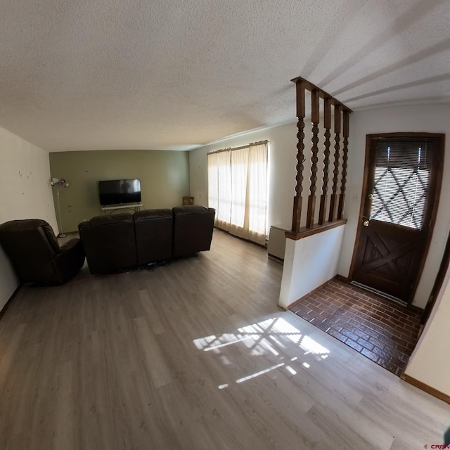 living area featuring a textured ceiling and wood finished floors